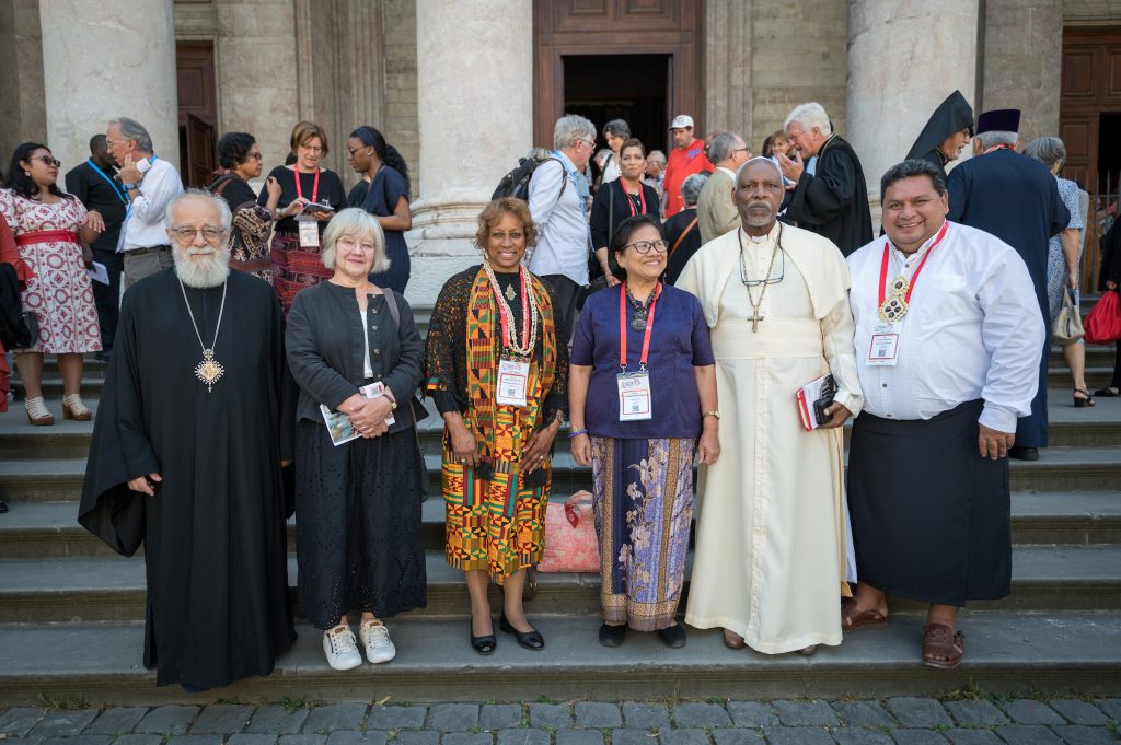 Six WCC regional presidents pictured outside the church, as the World Council of Churches central committee – gathered in Geneva on 21-27 June 2023 for its first full meeting following the WCC 11th Assembly in Karlsruhe in 2022 – joins local congregants at the St Pierre Cathedral in central Geneva to celebrate the 75th anniversary since the founding of the Council in 1948. Left to right: WCC president H.E. Metropolitan Dr. Vasilios of Constantia and Ammochostos of the Church of Cyprus; WCC president Rev. Dr Susan Durber of the United Reformed Church; WCC president Rev. Dr Angelique Walker-Smith of the National Baptist Convention USA; WCC president Rev. Dr Henriette Hutabarat-Lebang of Toraja Church (Indonesia); WCC president H.H. The Most Rev. Dr Rufus Okikiola Ositelu of the Church of the Lord (Prayer Fellowship) Worldwide; WCC president Rev. François Pihaatae of the Église protestante Maohi.