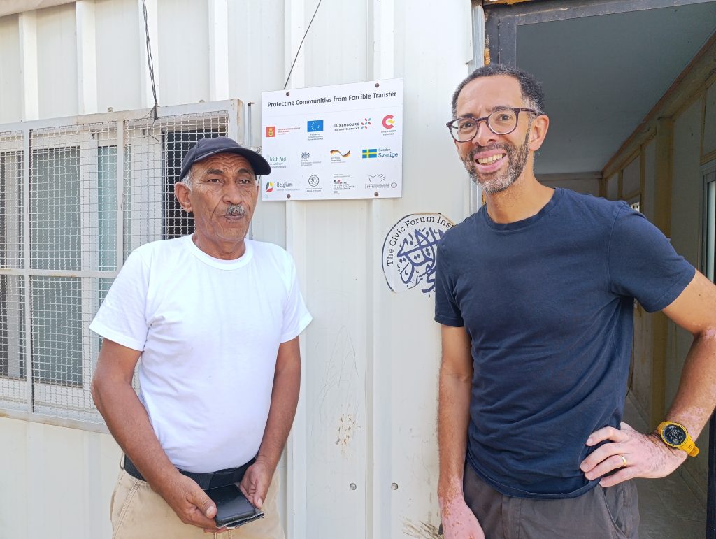 Ecumenical Accompanier Daniel standing next to a Palestinian man
