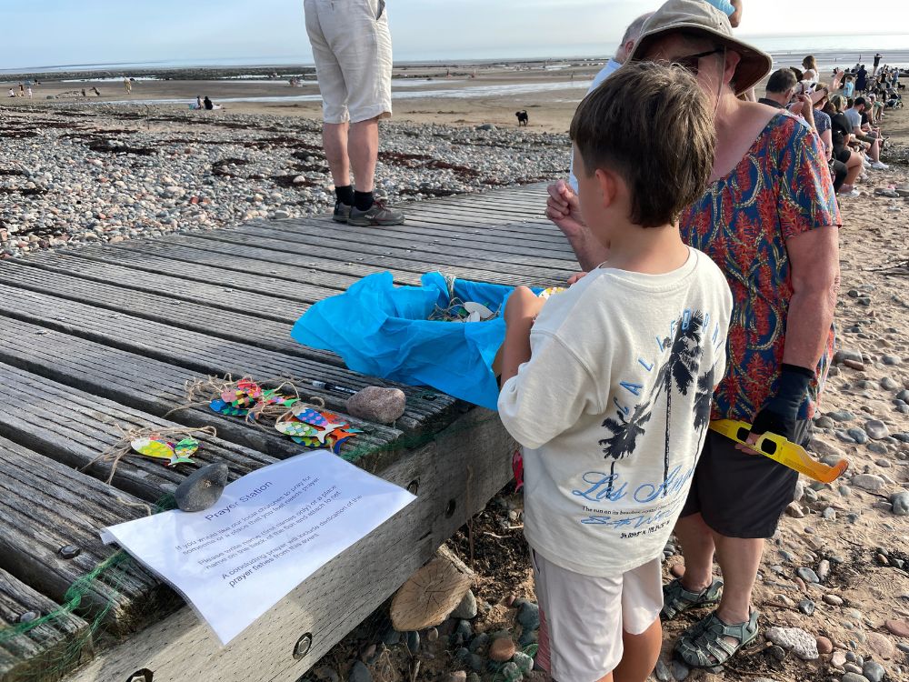 A child and a woman at the fish prayer station